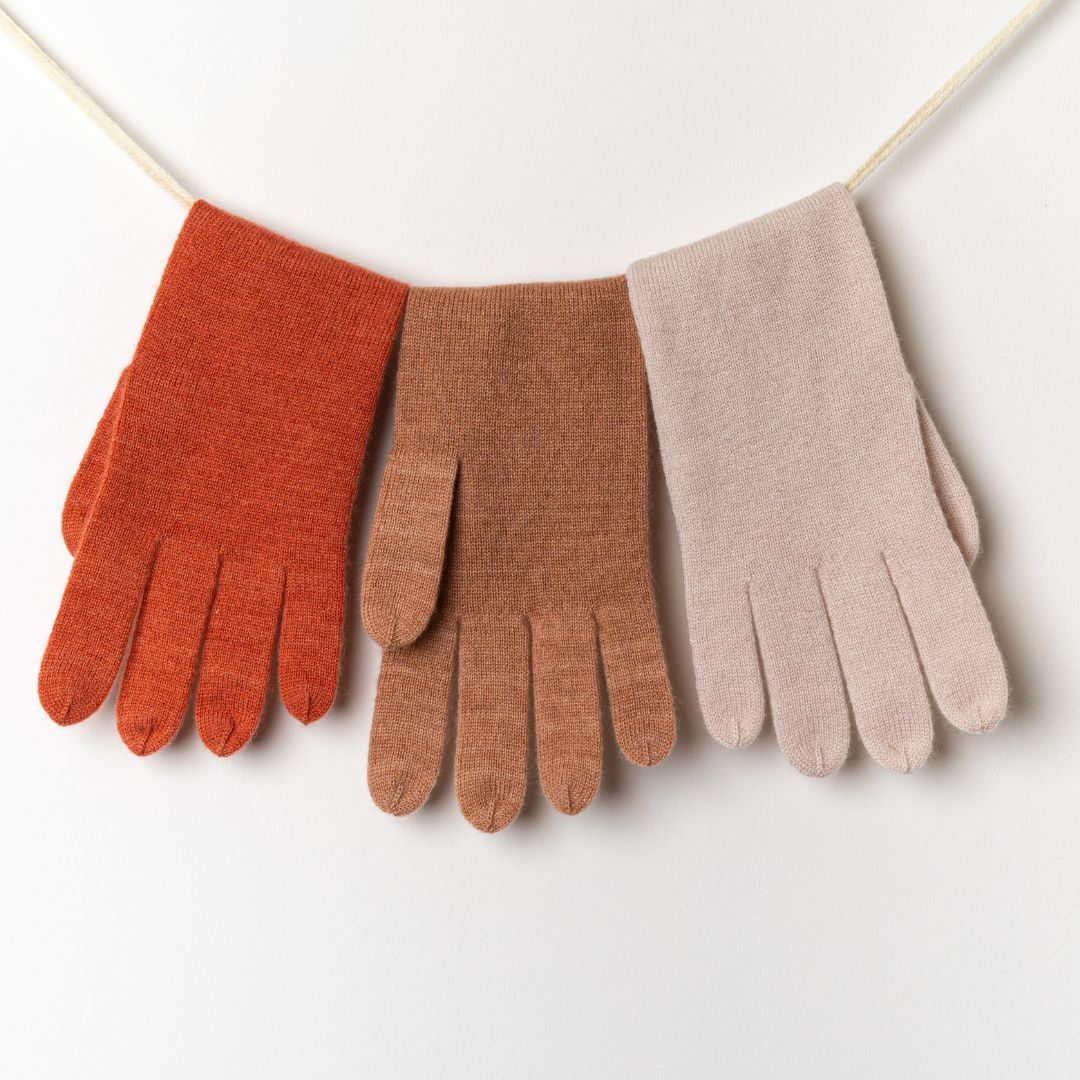 100% Cashmere Gloves Colors hanging in colors burnt sienna, cork, and sea salt