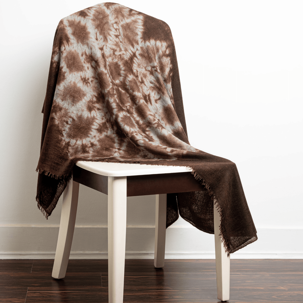 Brown with light tan fractal pattern 100% Cashmere Felted Shawl draped over a white chair with white background on dark brown wood floor#color_brown