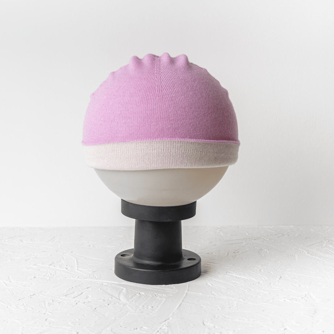 Reversible 100% Cashmere Beanie in Tender Touch(Pink) and Blanc de Blanc(White) on a mannequin ball#color_tender-touch-and-blanc-de-blanc